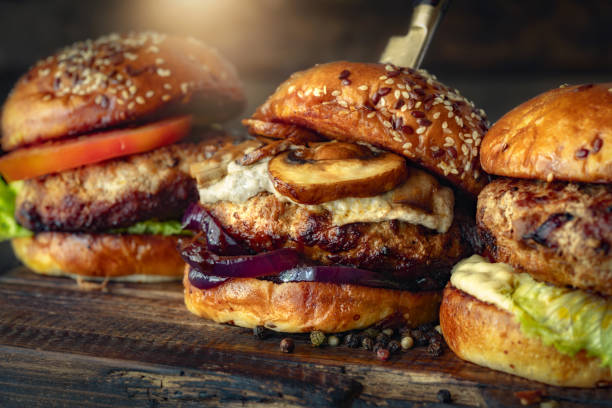 istock Three different brutal burgers on wooden board 1863925381