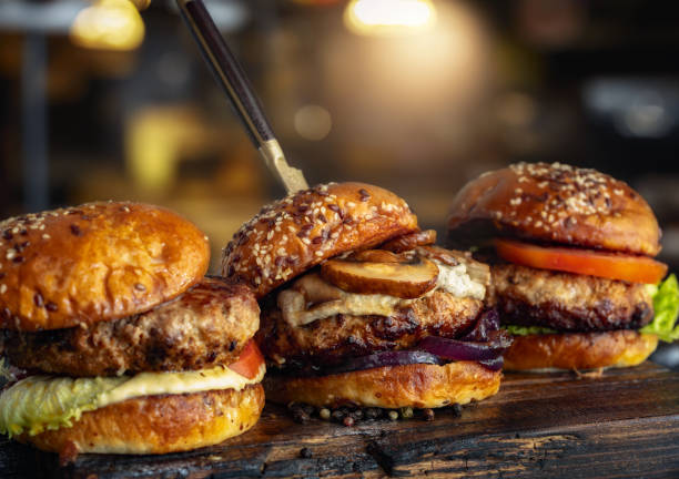 istock Three different brutal burgers on wooden board 1863927932