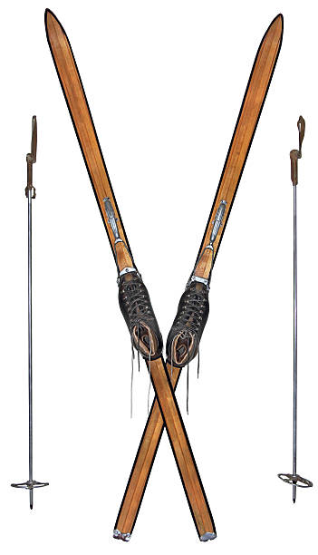 Old wooden skis and leather boots isolated on white background