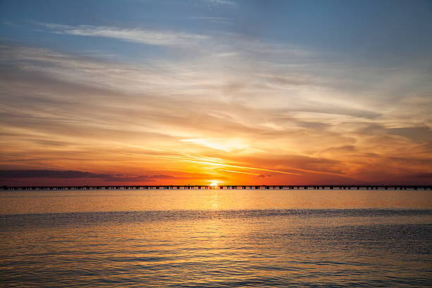 Causeway Sunset A colorful sunset featuring the Lake Pontchartrain Causeway in Louisiana causeway photos stock pictures, royalty-free photos & images