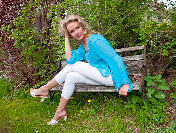 istock woman sitting on wooden bench 186394841