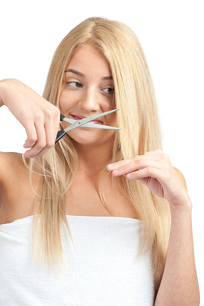 istock Woman cutting her hair with scissors 186395313