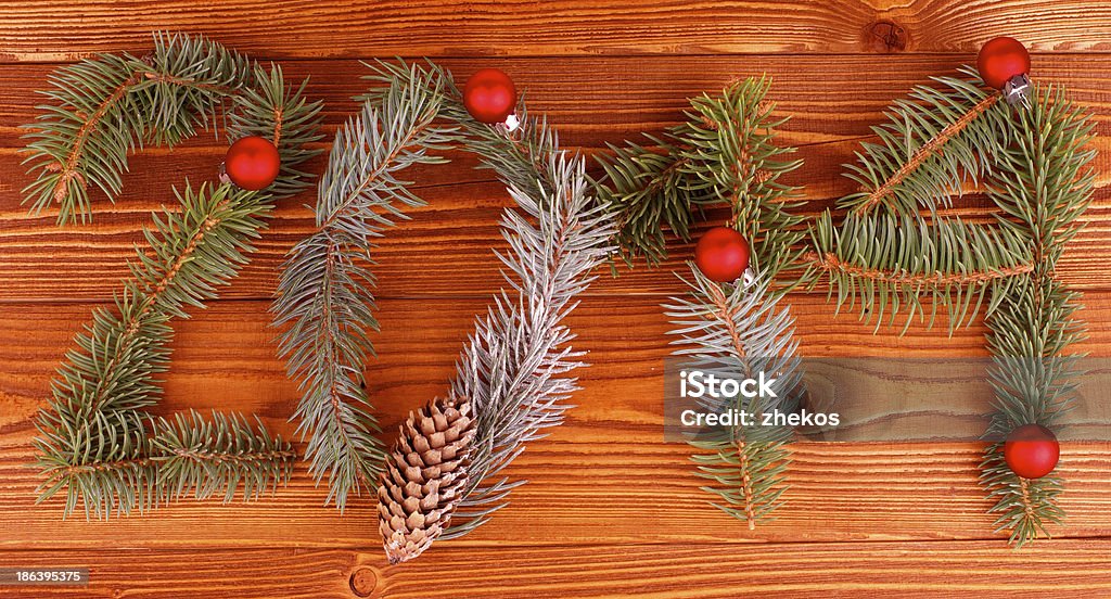 New Year 2014 Arrangement of Spruce Branch, Fir Cone and Red Baubles as New Year 2014 closeup on Wooden background 2013 Stock Photo