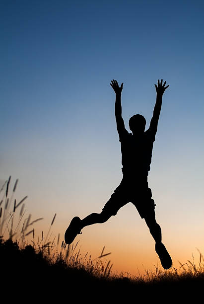 istock Silhouette of man jumping in field 186396064