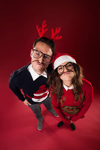 Nerd couple have fun with fake mustache Nerd couple have fun with fake mustache vintage nerd with reindeer sweater stock pictures, royalty-free photos & images
