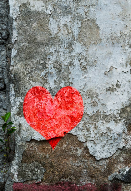 istock Red heart shape painting on old wall 1863983393