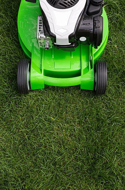 Old green lawn mower - Isolated on white background