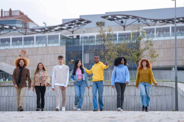 istock Friends walking confidently in a modern urban area. 1864049667