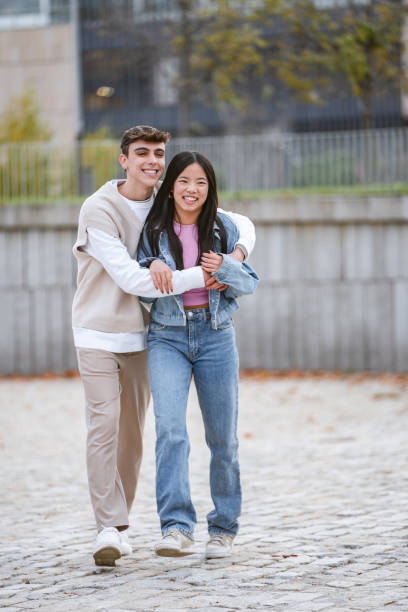 istock Man embracing his girlfriend while enjoying together outdoors. 1864054397