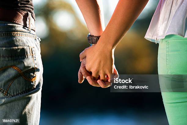 Couple Holding Hands Stock Photo - Download Image Now - Couple - Relationship, Holding Hands, Hands Clasped