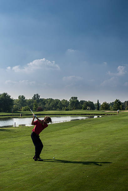 istock Golfer swinging the club 186407804