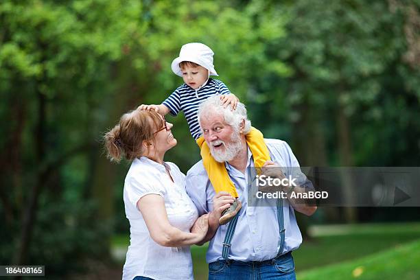 Outdoor Fun Stock Photo - Download Image Now - Picking Up, Grandchild, Grandfather