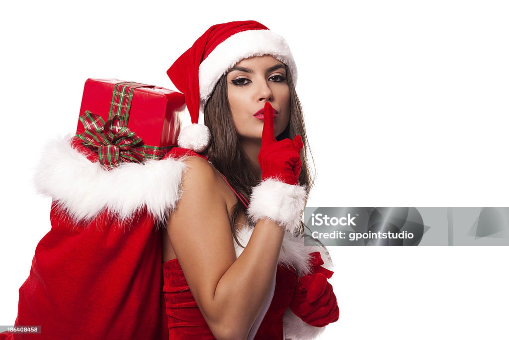 Sexy santa claus woman with christmas sack saying shh Sensuality Stock Photo