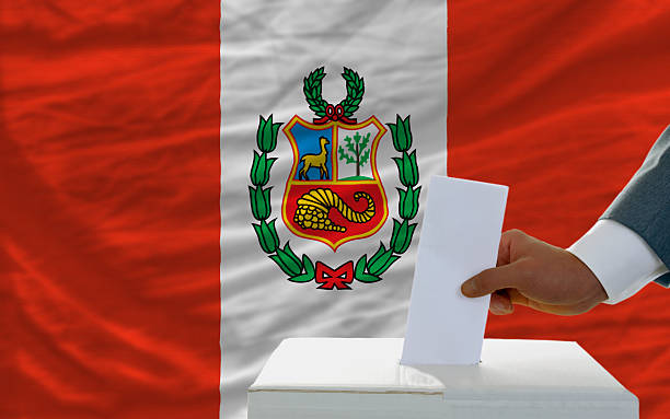 man voting on elections in peru front of flag stock photo