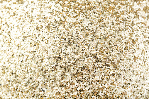 Close-up of golden sequins, backdrop.