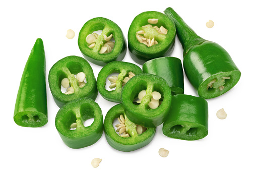 sliced green hot chili peppers isolated on white background clipping path. top view