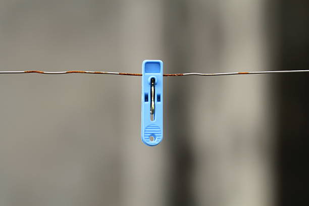 istock some different coloured clothes pegs on wet washing line 186411886