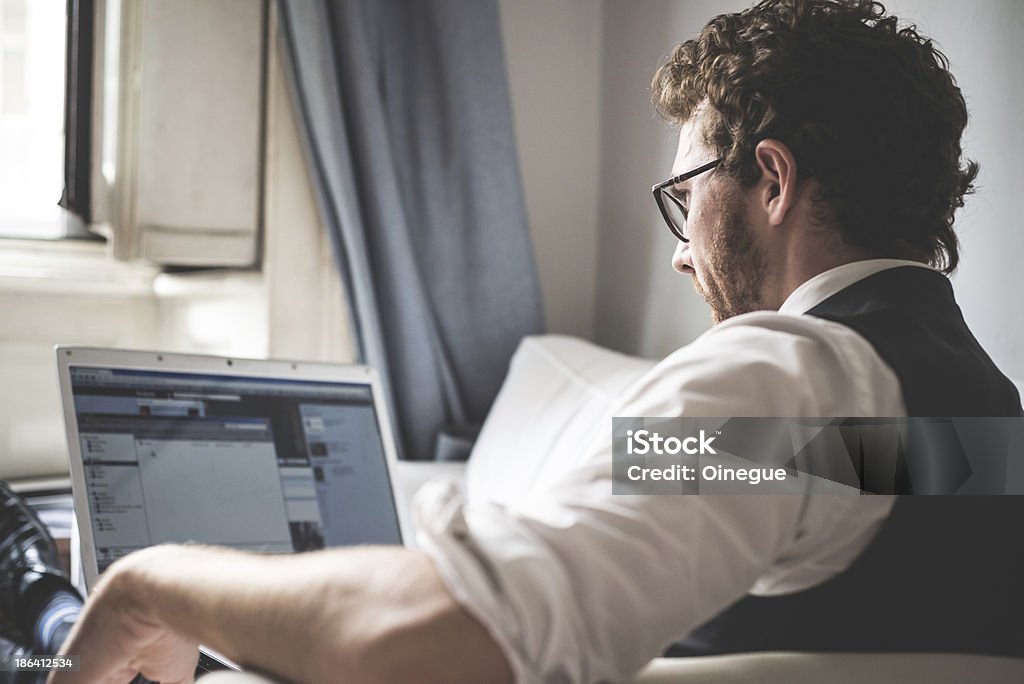 elegant attractive fashion hipster man using notebook elegant attractive fashion hipster man using notebook at home Adult Stock Photo
