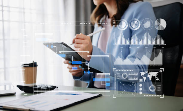 istock Businessman hand Project manager working and update tasks and Gantt chart scheduling virtual diagram.with smart phone, tablet and laptop in office. 1864126549