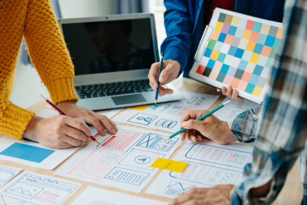 istock View of UI developer team brainstorming on their project with laptop, smartphone and digital tablet. Creative digital development agency. 1864127101