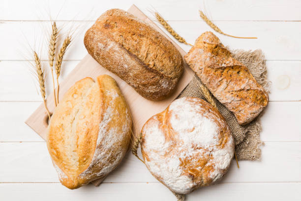 Homemade natural breads. Different kinds of fresh bread as background, top view with copy space Homemade natural breads. Different kinds of fresh bread as background, top view with copy space. hot mix plant stock pictures, royalty-free photos & images