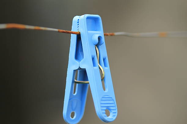 istock some different coloured clothes pegs on wet washing line 186413902