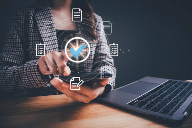istock Businesswoman working on laptop with electronics document icons by virtual notebook screen. Auditing and evaluating quality, efficiency of personnel, E-document management Paperless workplace concept. 1864145738