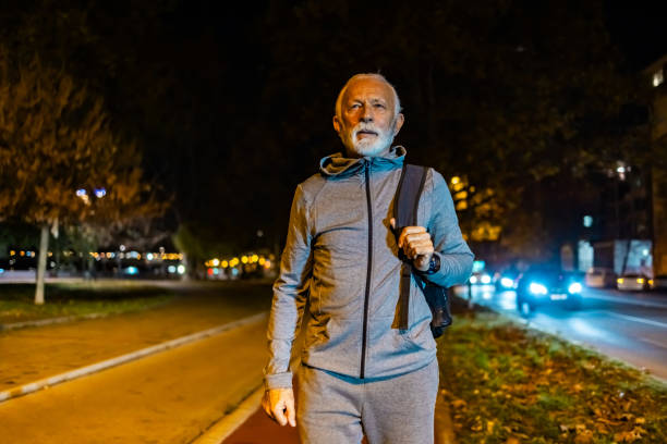 istock Senior man wearing his backpack at night outdoors. 1864164694