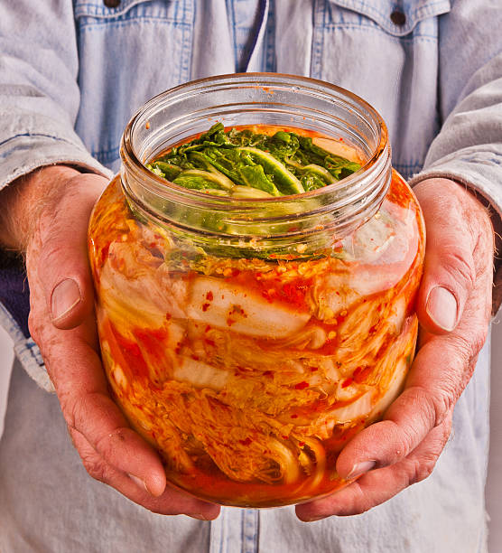 Man holding jar of homemade kimchi stock photo