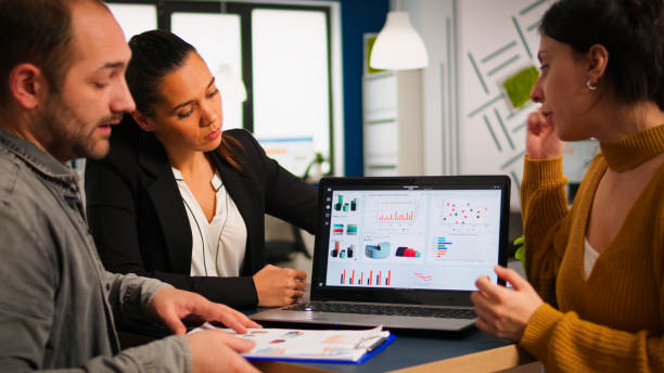 istock Business people talking with team leader using clipboard with documents 1864195250