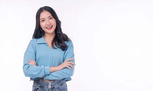 Confident success asian woman standing arms crossed on white background. Positive charming young woman wear casual smiling arms crossed over isolated. Successful occupation lifestyle concept.