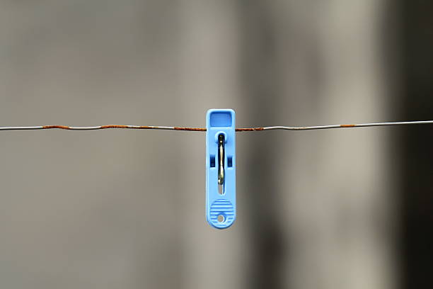 istock some different coloured clothes pegs on wet washing line 186419928