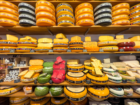 Amsterdam, Holland, 12.13.2022: Souvenir cheese shop with various slices on display. The finest selection of artisanal cheeses from all over the Netherlands, including creamy Gouda and tangy Edam. Travel destination and food background.