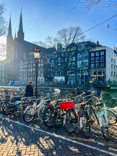 istock Bicycle park next to a canal in Amsterdam on sunny day 1864222474