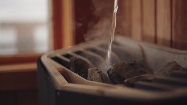 Pouring water on the heater in the sauna