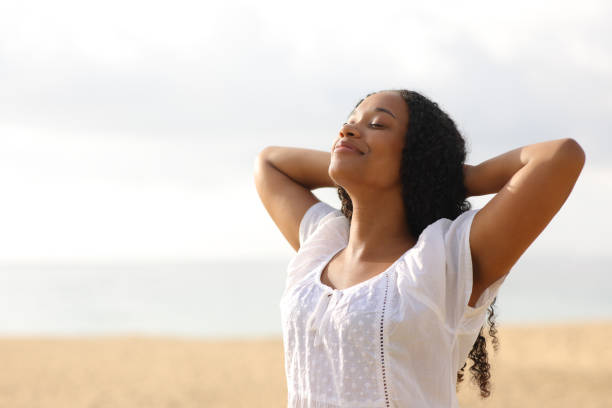 istock Black woman resting breathing on the beach 1864244239
