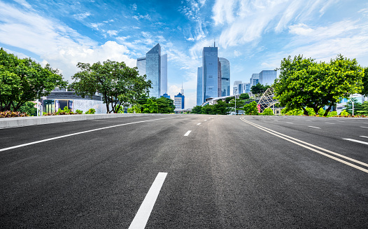 Clean road and city buildings landscape in summer