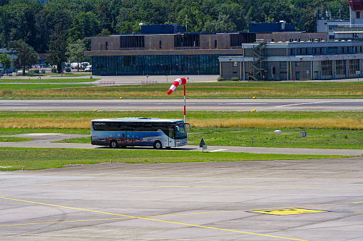 Red and white striped windsock waving at Zürich Kloten Airport on a sunny summer day. Photo taken July 23rd, 2023, Kloten, Canton Zürich, Switzerland.