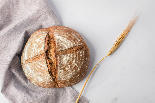 istock Freshly baked round bread with a crispy brown crust. 1864260045