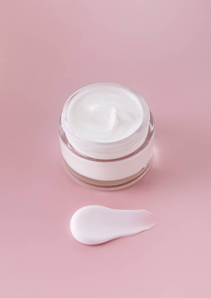 istock cream jar cosmetic smear cream texture on pastel pink background 1864260067