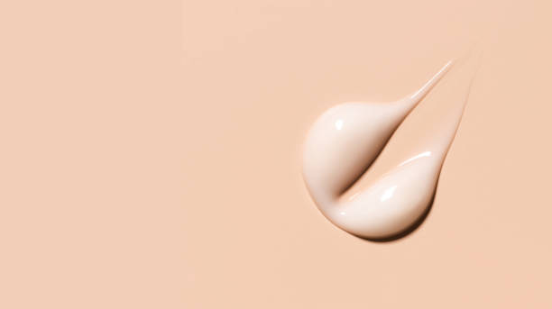 istock cosmetic smear texture on pastel beige background 1864260596