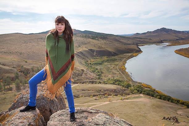 istock woman on a rock in the mountains 186426334
