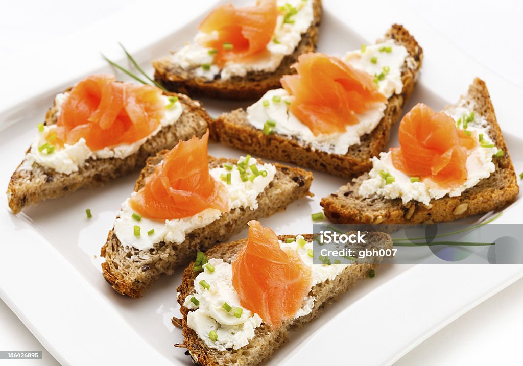 Sandwiches with smoked salmon Healthy eating - sandwich with white cheese, salmon and chives   Appetizer Stock Photo