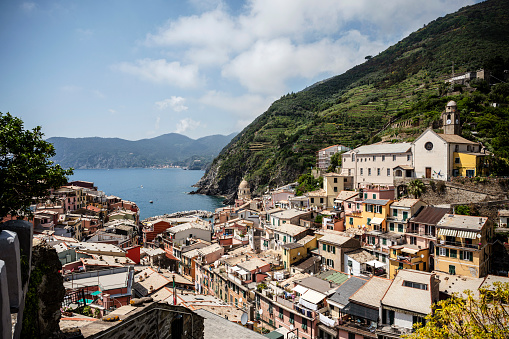 View of the small village of Vernazza with the church of Santa Margherita di Antiochia on the Ligurian coast, which is one of the five centuries-old villages of the Cinque Terre in summer.