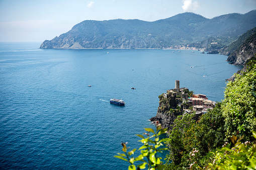 View of the medieval Doria rock castle and the small village of Vernazza on the Ligurian coast, which is one of the five centuries-old villages of the Cinque Terre in summer.