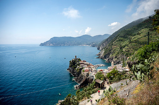 View of the medieval Doria rock castle and the small village of Vernazza on the Ligurian coast, which is one of the five centuries-old villages of the Cinque Terre in summer.