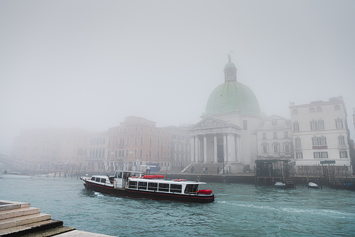 Grand Canal in Venice, Italy on a foggy winter day, view from the pier on \