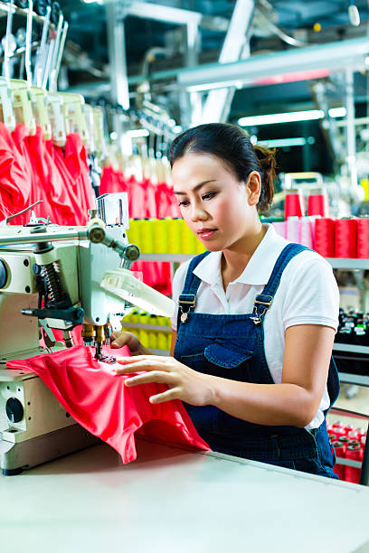 istock Chinese seamstress in a textile factory 186428539