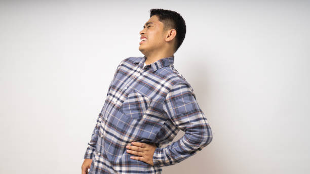 istock Young Asian man wearing shirt suffer low back pain on white background 1864290175