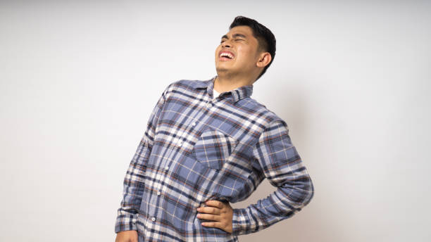 istock Young Asian man wearing shirt suffer low back pain on white background 1864291721